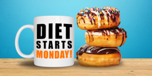 A mug with the slogan "Diet starts Monday!" next to 3 chocolate iced doughnuts